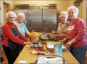  ??  ?? Jane Kinder, Anna Brown, Betty Clark, and Mary Graefe of St. Paul’s Lutheran Church of Douglassvi­lle prepare a meal for Hope Rescue Mission of Reading.