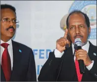  ?? ?? Hassan Sheikh Mohamud (right) speaks May 15 after his election win next to incumbent leader Mohamed Abdullahi Mohamed at the Halane military camp in Mogadishu.