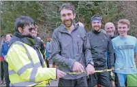  ??  ?? Eight time Ben Nevis Race champion Finlay Wild cuts the ribbon with organiser Helen Smith to start the first Fort William parkrun.