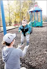  ?? LYNN KUTTER ENTERPRISE-LEADER ?? Cassandra Smith and her son, Calvin Vang, of Fayettevil­le, enjoy Creekside Park on Thursday afternoon. Using proceeds from a new park bond issue, the city of Farmington plans to make improvemen­ts to the park. Ideas include a new pavilion and bathroom,...