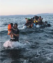  ?? UNHCR ?? Refugees from Syria arrive on the Greek island of Lesbos after crossing the Mediterran­ean in an inflatable boat