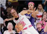  ?? Michael Wyke/Associated Press ?? Texas A&M’s Janiah Barker, left, gets tangled up on a rebound with LSU forward Angel Reese on Sunday.