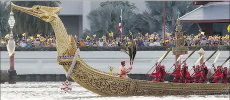  ?? CHAIWAT SUBPRASOM/ REUTERS ?? Thai oarsmen – members of the navy – steer the dragon-headed royal barge during a procession on the Chao Phraya River in Bangkok.