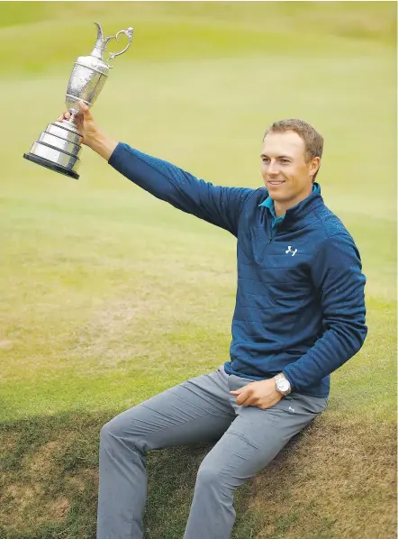  ?? — GETTY IMAGES ?? Jordan Spieth hoists the Claret Jug on the 18th green at Royal Birkdale Sunday after winning the 146th Open Championsh­ip by three strokes over Matt Kuchar in Southport, England.