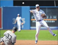  ?? CP PHOTO ?? Toronto Blue Jays’ shortstop Ryan Goins, right, throws to first base to complete a double play after forcing out New York Yankees’ Greg Bird at second base during the third inning of a game Sunday in Toronto.