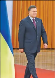  ?? WU ZHIYI / CHINA DAILY ?? Visiting Ukrainian President Viktor Yanukovych attends a welcoming ceremony held for him at the Great Hall of the People in Beijing on Thursday.