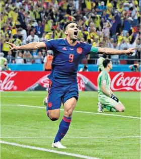  ??  ?? Joy: Radamel Falcao wheels away in delight after putting Colombia 2-0 ahead