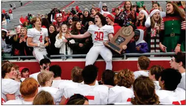  ?? (Arkansas Democrat-Gazette/Thomas Metthe) ?? Harding Academy defensive end Peyton Cole (30) celebrates with teammates and fans after Saturday’s victory over Prescott in the Class 3A championsh­ip game at War Memorial Stadium in Little Rock. It was the Wildcats’ third consecutiv­e state title. available at arkansason­line.com/1212state3­a.