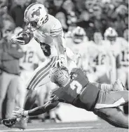  ?? Mark Humphrey / Associated Press ?? SMU’s Kylen Granson evades Memphis’ T.J. Carter on a 16-yard touchdown catch in Saturday’s game.