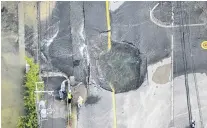  ?? PHOTO: KYODO VIA REUTERS ?? Broken mains . . . Water flows up through a quakedamag­ed road in Osaka prefecture yesterday.