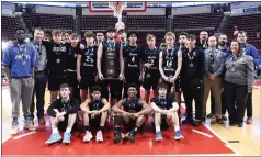  ?? BILL UHRICH - READING EAGLE ?? Exeter Township gathers for a group photo with the runner-up trophy following their PIAA Class 5A boys basketball loss to Imhotep Charter Friday at the Giant Center in Hershey.