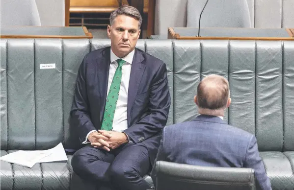  ?? Picture: GARY RAMAGE ?? SITTING PRETTY: Corio MP Richard Marles (left) and federal Labor leader Anthony Albanese practise social distancing in parliament.