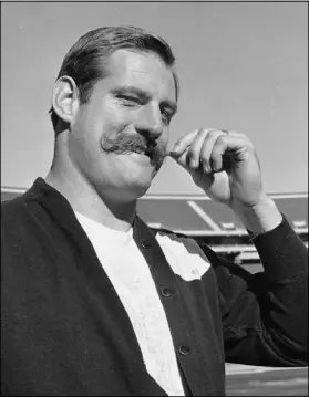  ?? Ernest Bennett The Associated Press ?? Raiders defensive end Ben Davidson playfully twirls his handlebar mustache, ala 1960s TV cartoon character Snidely Whiplash, as he talks about playing the Green Bay Packers for the NFL championsh­ip in 1968 in what became known as Super Bowl II.
