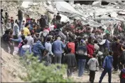  ?? ?? Palestinia­ns rush to collect the humanitari­an aid airdropped into Gaza City, Gaza Strip, on Sunday.