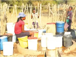  ??  ?? Gogo Mercy Chibaya (right) and Medline Bangajena wait for their turn to draw wat zou Village in Chitsungo