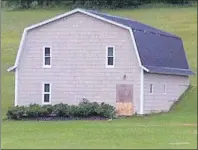  ?? LAURA JEAN GRANT/CAPE BRETON POST ?? On Sunday morning a boarded up barn door seen from West Side Middle River Road was one of the only signs of an ultralight plane crash the evening before. One man was killed in the crash, and another was airlifted to hospital in Halifax. The plane has...