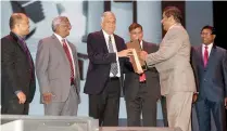  ??  ?? Kapila Ariyaratne – Director / CEO of Seylan Bank receiving the award from Prime Minister Ranil Wickremesi­nghe