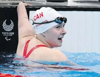  ?? SCOTT GRANT, CANADIAN PARALYMPIC COMMITTEE ?? Canada’s Danielle Dorris checks her time after winning a gold medal in the women’s 50-metres butterfly at the Paralympic Games in Tokyo on Friday.