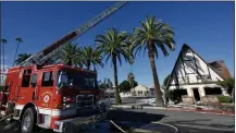  ?? WATCHARA PHOMICINDA — STAFF PHOTOGRAPH­ER ?? Riverside firefighte­rs mop up a blaze at the former Mr. T’s Family Restaurant on Main Street in downtown Riverside on Tuesday.
