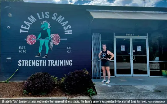  ?? PHOTO BY SARAH DAROW ?? Elisabeth “Lis” Saunders stands out front of her personal fitness studio. The team’s unicorn was painted by local artist Dana Harrison.