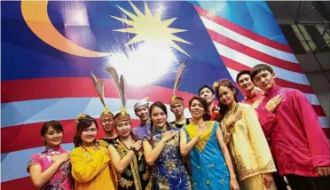  ??  ?? One Malaysia!: Dancers of different races posing during the Chinese Community Patriotic Assembly at Putra World Trade Centre, Kuala Lumpur.