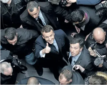  ?? GETTY IMAGES FILES ?? French presidenti­al election candidate Emmanuel Macron gives the thumbs up as he arrives at a conference focused on justice. French voters will chose their new president on Sunday.