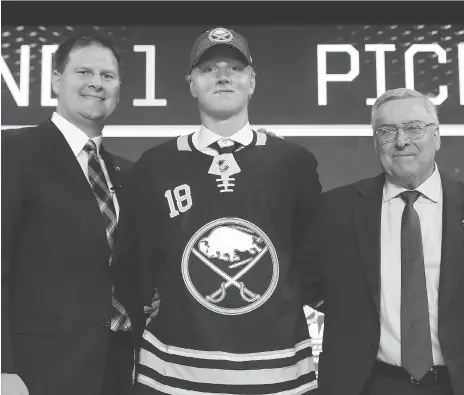  ?? GETTY IMAGES ?? Swedish defenceman Rasmus Dahlin dons his Buffalo Sabres jersey after being selected first overall at Friday’s NHL draft in Dallas.