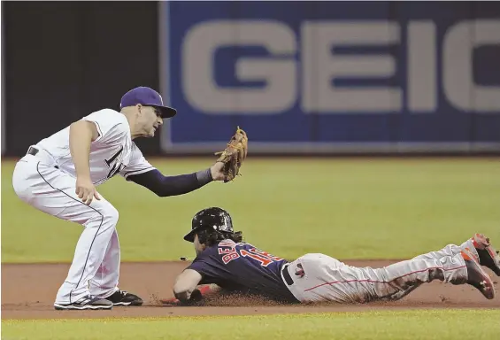  ?? Ap pHOTO ?? THEY’VE BEEN CAUGHT: Andrew Benintendi tries unsuccessf­ully to steal second base as the Rays’ Danny Espinosa prepares to put down the tag during last night’s game in St. Petersburg, Fla.