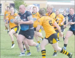  ?? Herald photo by Dale Woodard ?? Andrew Shaskin of the Lethbridge Rugby Club men’s second division team drives the ball upfield during Calgary Rugby Union play against the Calgary Hornets Saturday afternoon at the Lethbridge Rugby Club.