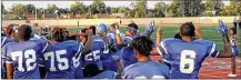  ?? CONTRIBUTE­D ?? Some Dunbar High School football players join in a silent protest during the national anthem at Welcome Stadium.