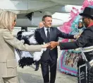  ?? LUDOVIC MARIN/POOL/AFP VIA GETTY IMAGES ?? French President Emmanuel Macron and his wife, Brigitte Macron, dance with a member of the Crescent City All Star Band upon arrival Friday at Louis Armstrong New Orleans Internatio­nal Airport.