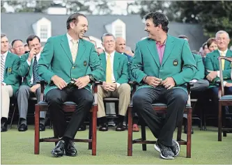  ?? GETTY IMAGES FILE PHOTO ?? Patrick Reed, right, reacts with Sergio Garcia after being presented with the green jacket in honour of winning the 2018 Masters at Augusta National Golf Club on April 8 in Augusta, Ga.