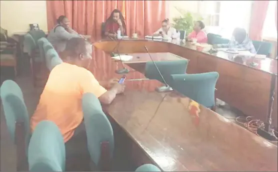  ??  ?? Members of the city’s renegotiat­ing committee awaiting public transport operators in the almost empty Council Chambers on Wednesday.