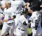  ?? David Zalubowski ?? The Associated Press Carlos Gonzalez restrains Rockies teammate Nolan Arenado during a third-inning scuffle Wednesday in Colorado’s 6-4 win over the Padres at Coors Field.