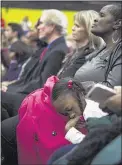  ??  ?? Kinslee Miller, 7, naps as a diverse standing-room-only crowd of more than 650 listens to the former president.