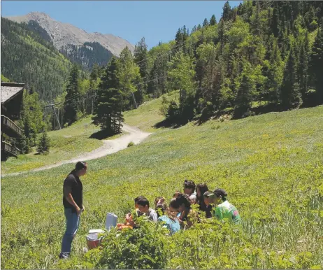  ?? COURTESY TAOS BEHAVIORAL HEALTH ?? Taos Behavioral Health’s 2022 summer programs have included excursions outdoors. Here, youth take a break on the slopes around Taos Ski Valley during a past summer program.