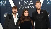  ?? Associated Press ?? ■ Dave Haywood, from left, Hillary Scott and Charles Kelley, of Lady A, formerly Lady Antebellum, arrive at the 52nd annual CMA Awards in Nashville, Tenn.