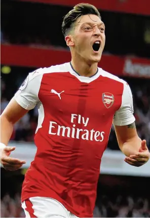  ??  ?? AWESOME OZIL Gunners ace Mezut celebrates his killer third yesterday