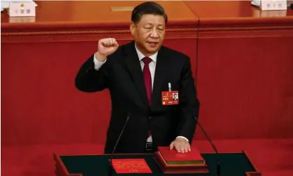  ?? Mark R Cristino/EPA ?? President Xi Jinping holds up his fist and places his hand on China’s constituti­on in the Great Hall of the People in Beijing Photograph: