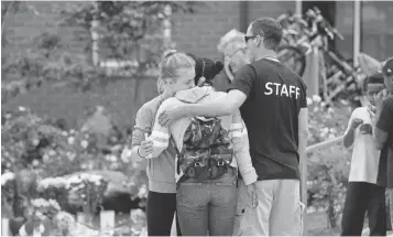  ?? ELAINE THOMPSON, AP ?? Mykla Gainey, left, and Zamirah Cacho embrace at a memorial for Charleena Lyles, a pregnant mother fatally shot by a Seattle police officer responding to a burglary call on June 19.