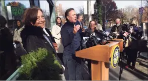  ?? Arnold Gold / Hearst Connecticu­t Media ?? Claire Criscuolo, left, owner of Claire’s Corner Copia, listens to Gov. Ned Lamont announce that the family and medical leave program began taking applicatio­ns during a news conference in front of Claire's Corner Copia in New Haven on Wednesday.