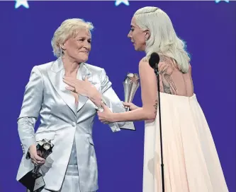  ?? CHRIS PIZZELLO THE ASSOCIATED PRESS ?? Glenn Close, left, and Lady Gaga react after winning the awards for best actress in a tie at the 24th annual Critics' Choice Awards. Close won for her role in "The Wife" and Lady Gaga won for her role in "A Star Is Born."