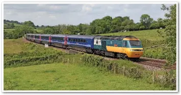  ?? MARK PIKE. ?? The AT300s are replacing High Speed Trains dating from 1976. On June 3, the first-built production power car, 43002 Sir Kenneth Grange, tails the 1006 London Paddington-Penzance through Cole (Wiltshire).