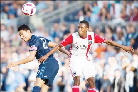  ??  ?? Sporting Kansas City midfielder Roger Espinoza (left), hits the ball away from San Jose Earthquake­s forward Cordell Cato during the second half of an MLS soccer
game on Oct 23, at Children’s Mercy Park in Kansas City, Kansas. Sporting won the game 2-0...