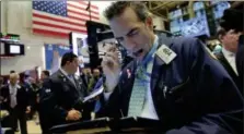  ?? RICHARD DREW — THE ASSOCIATED PRESS ?? Trader Gregory Rowe works on the floor of the New York Stock Exchange, Monday.