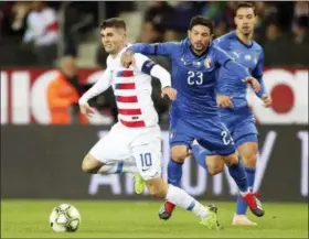  ?? FRANCISCO SECO — ASSOCIATED PRESS ?? United States’ Christian Pulisic, left, and Italy’s Stefano Sensi fight for the ball during an internatio­nal friendly Nov. 20 in Genk, Belgium.