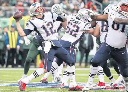  ?? AFP ?? New England quarterbac­k Tom Brady, No.12, attempts a pass against the New York Jets at East Rutherford.