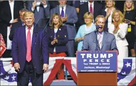  ?? Gerald Herbert Associated Press ?? NIGEL FARAGE, right, then the leader of the right-wing U.K. Independen­ce Party, appears with Donald Trump at a 2016 campaign rally in Jackson, Miss.