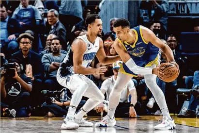  ?? Stephen Lam/The Chronicle ?? Warriors forward Patrick Baldwin Jr. (right) is guarded by Orlando Magic guard Jalen Suggs during their game on Jan. 7.