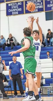  ??  ?? O’reilly Matthews shoots over Murray Countys’ Lincoln Puryear during a game early last week. Matthews had 22 points in the Tigers’ first win of the season against Rockmart on Friday.